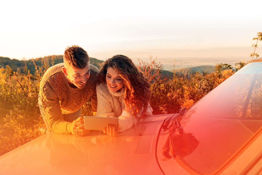 Couple leaning on car