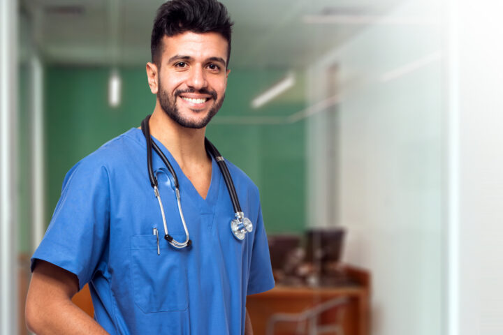 Male nurse in blue scrubs with stethoscope