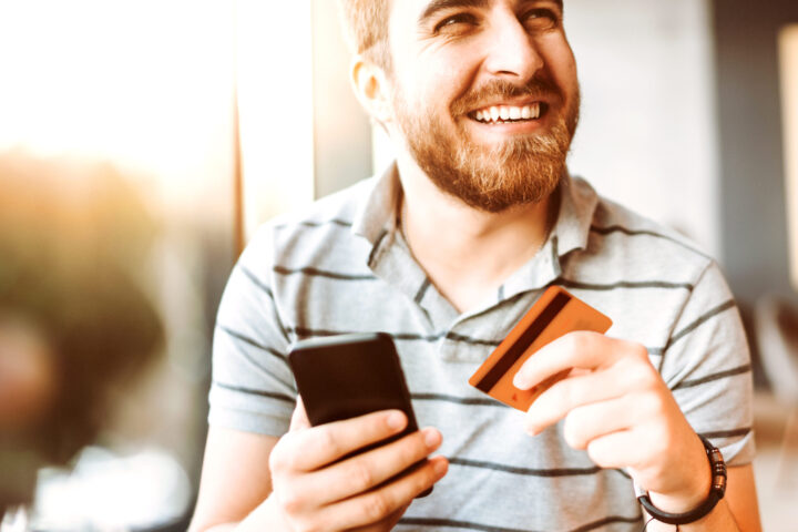 Man with cell phone and credit card