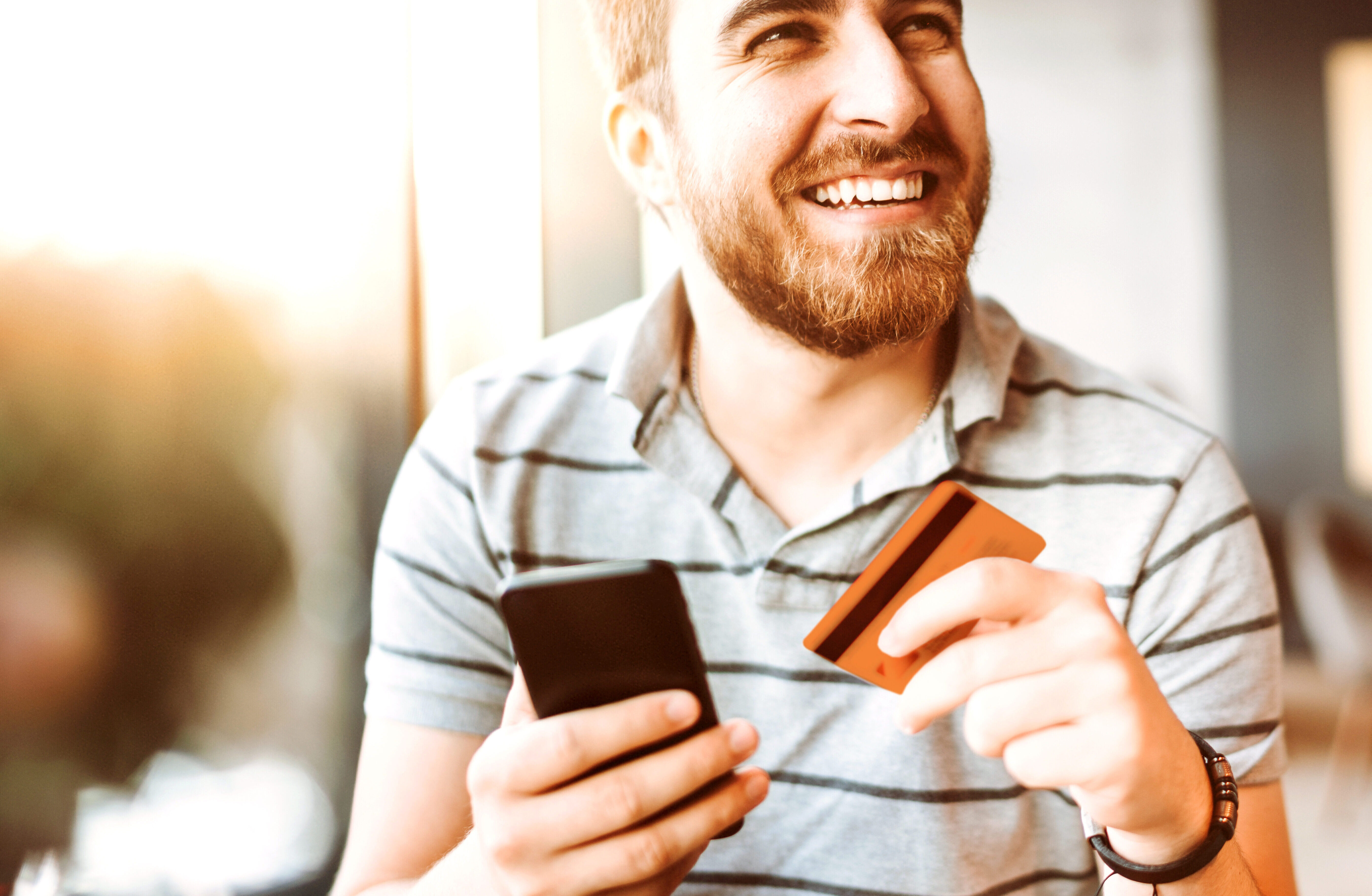 Man with cell phone and credit card