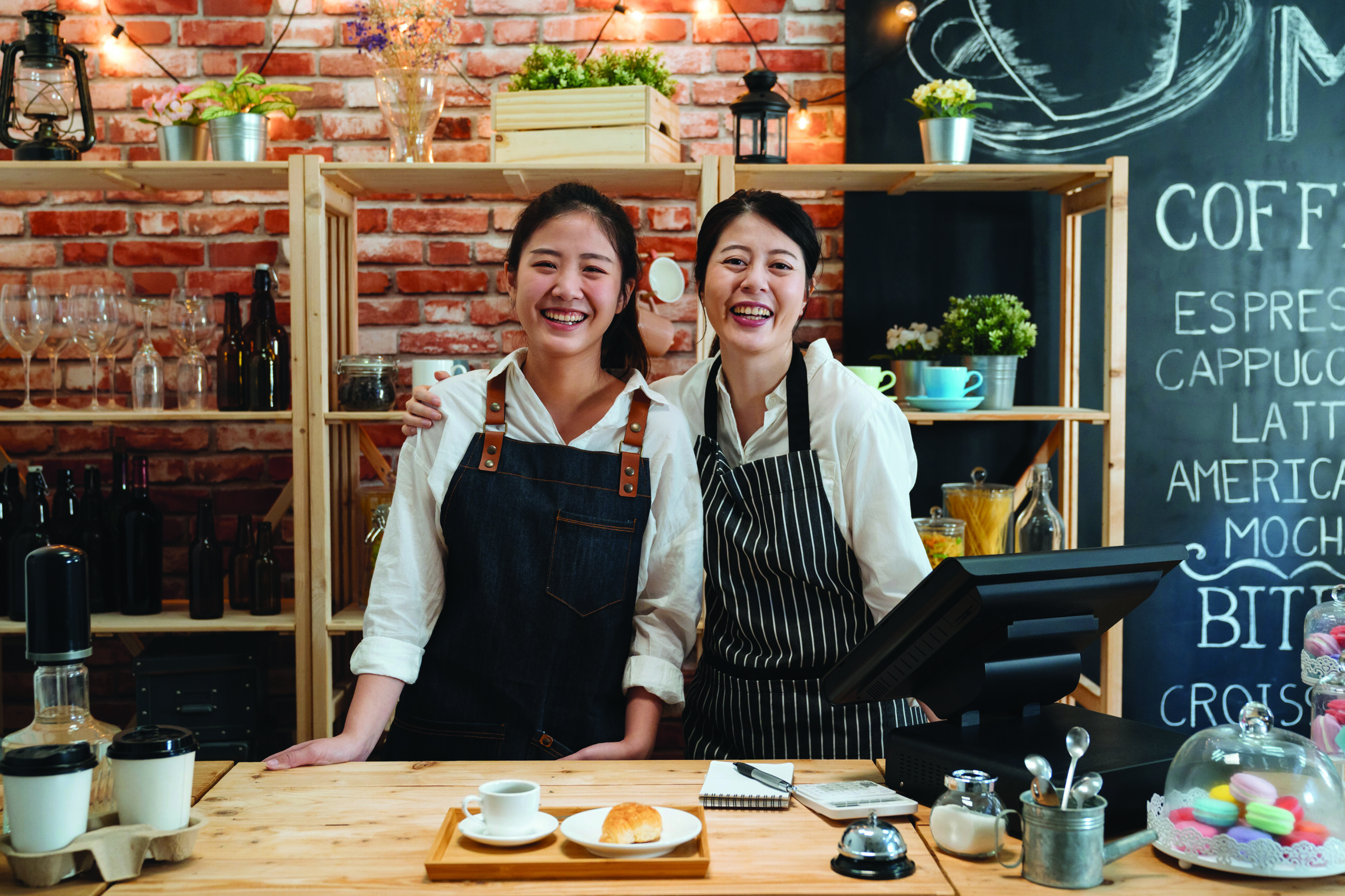 happy coffeehouse waitresses smiling confidently