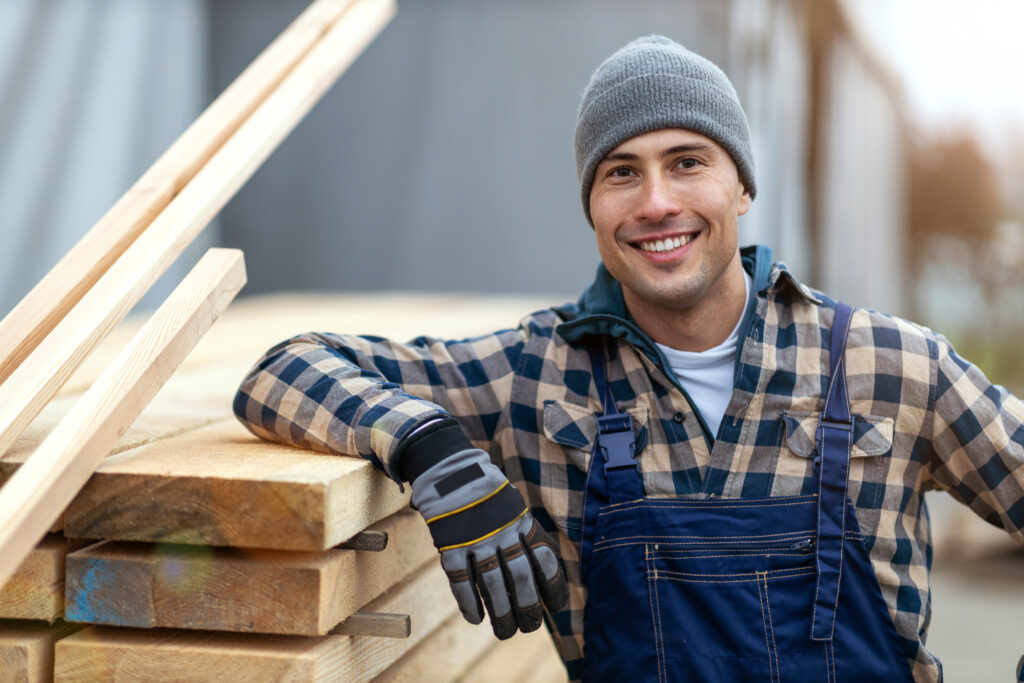 Young male worker in timber warehouse