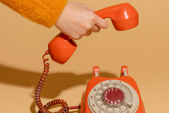 Woman answering an old retro telephone