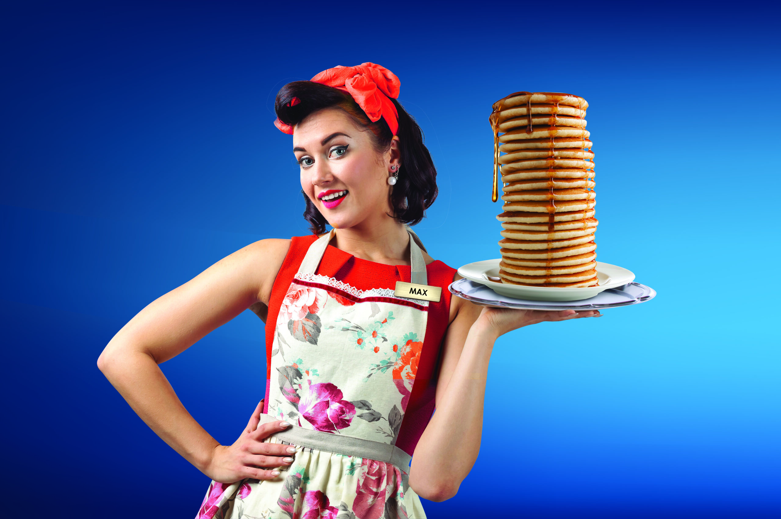 Woman holding a tall stack of pancakes
