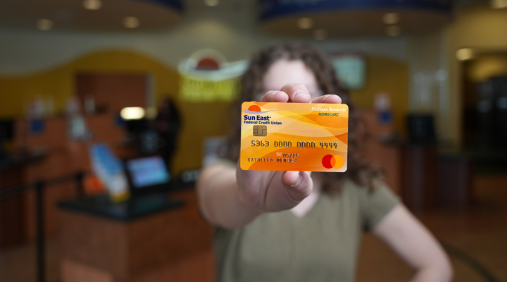 young woman holding card in front of her face