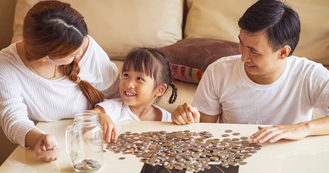 Man and Woman with Little Girl Counting Coins