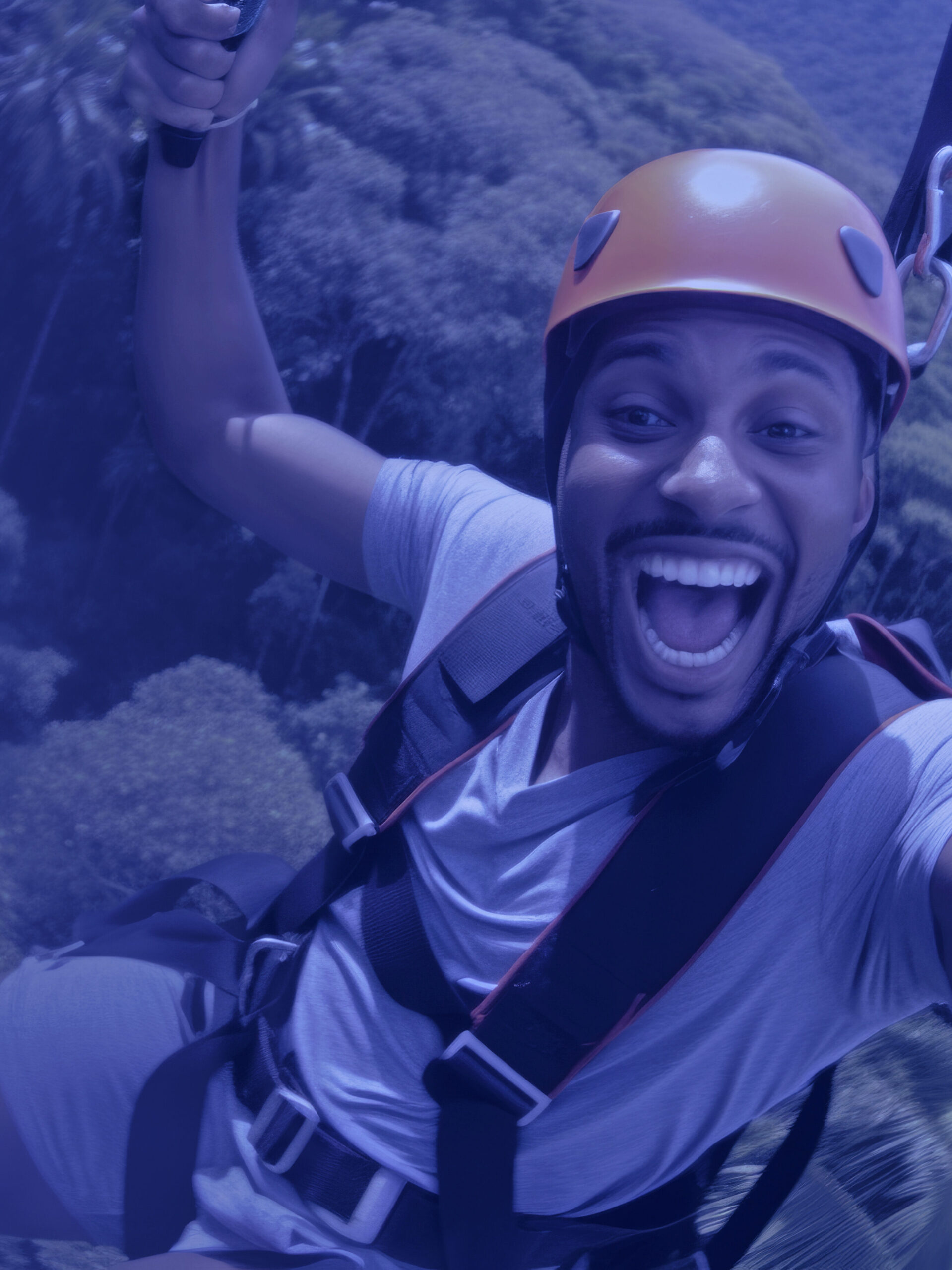 Young man engaged in a thrilling ziplining adventure through a dense rainforest canopy. He soars above the treetops, he laughter and excitement echoing through the jungle.