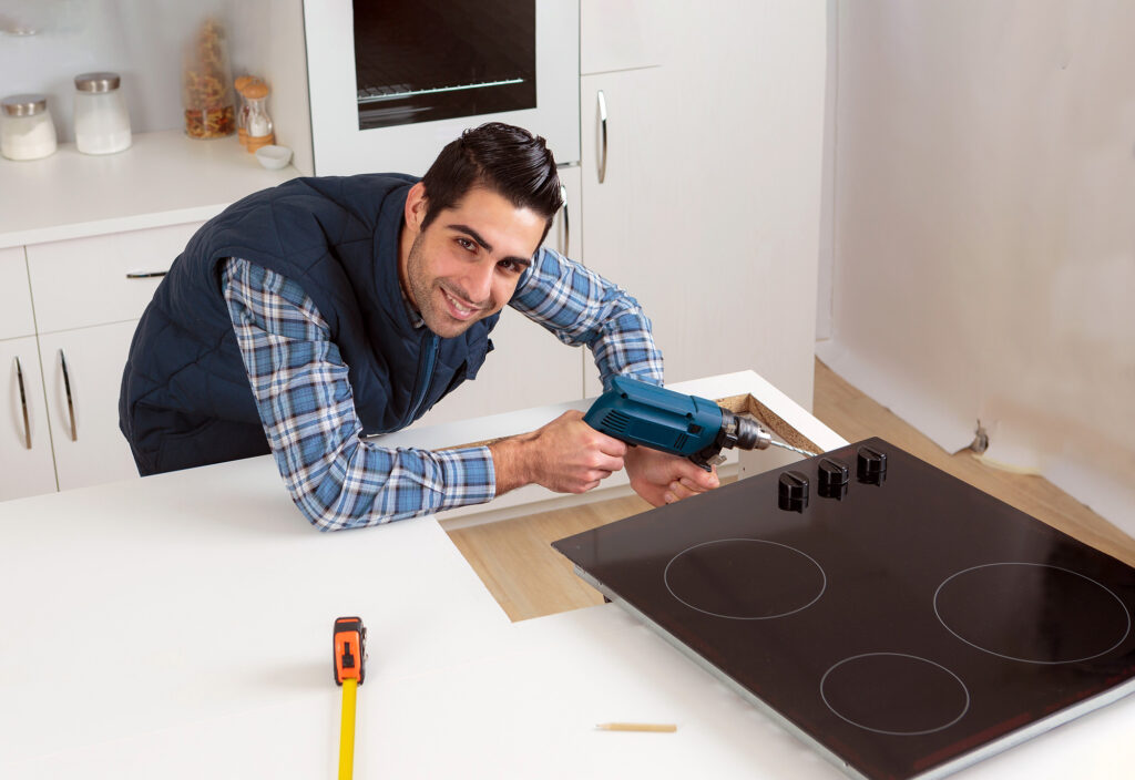 Man fixing stove top