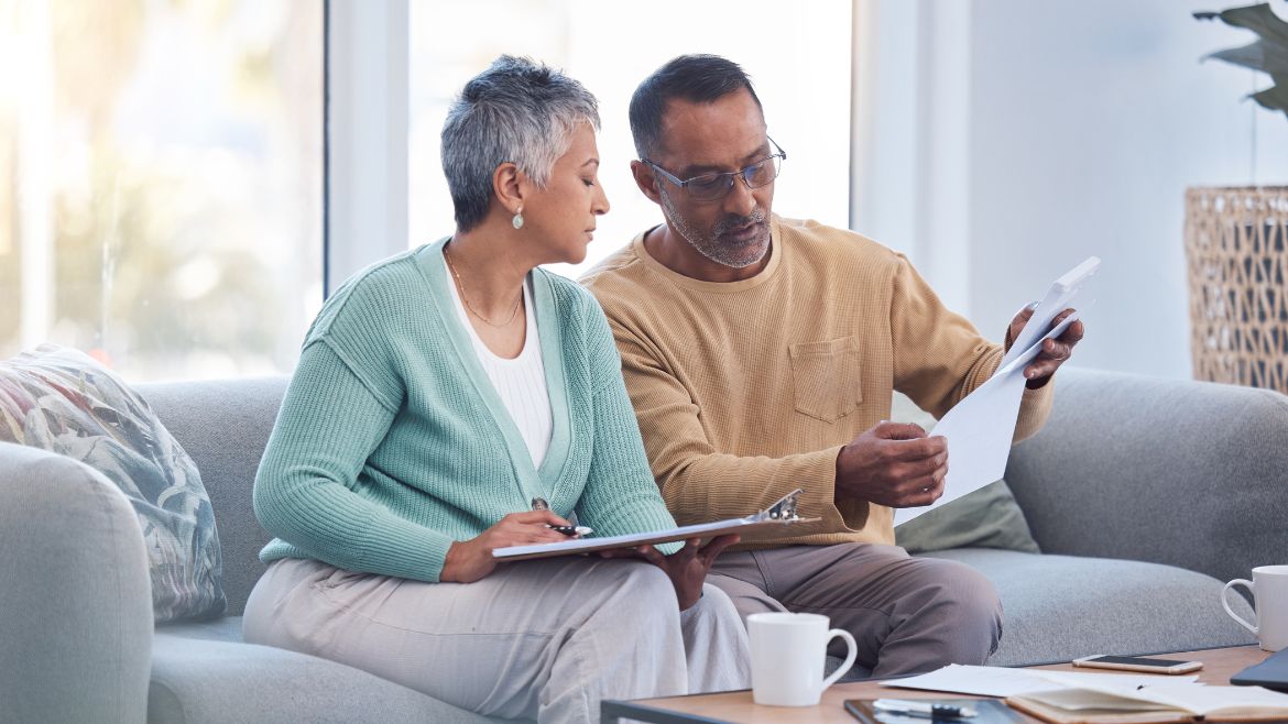 two adults looking at a stack of documents