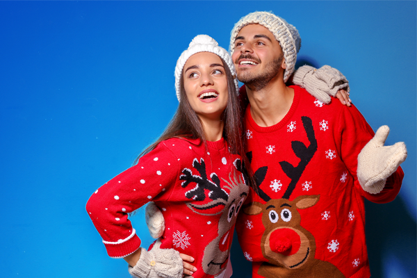 couple dressed in "ugly" reindeer sweaters