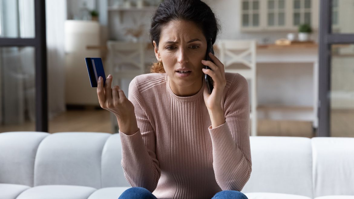 Woman on cell phone with credit card